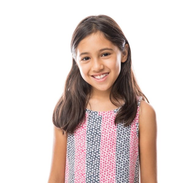 Portrait of young beautiful little girl with t-shirt smiling to camera over white background